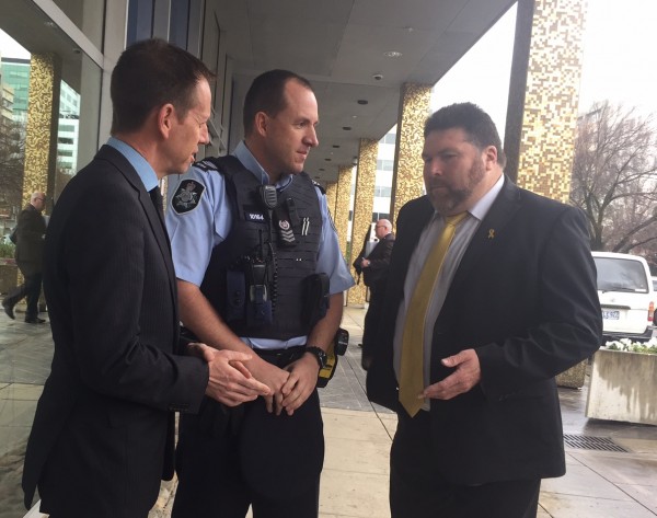 Shane Rattenbury, left, and Peter Frazer, right, discussing distracted driving.
