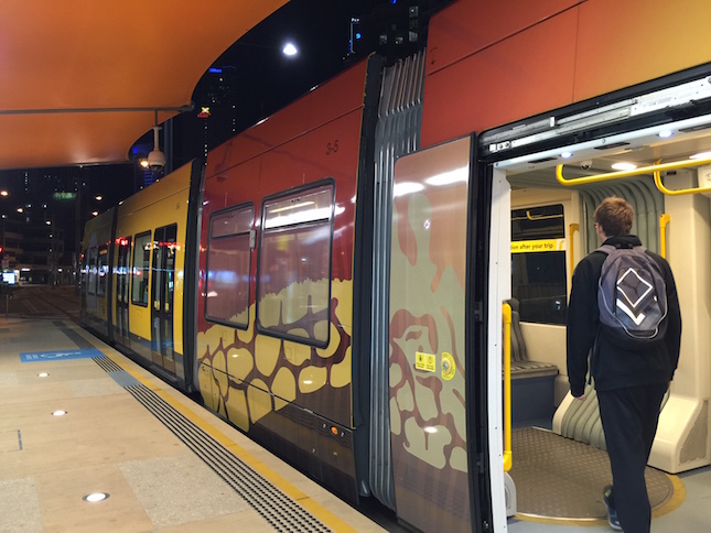 Gold Coast light rail passenger with backpack. Photo: Charlotte Harper