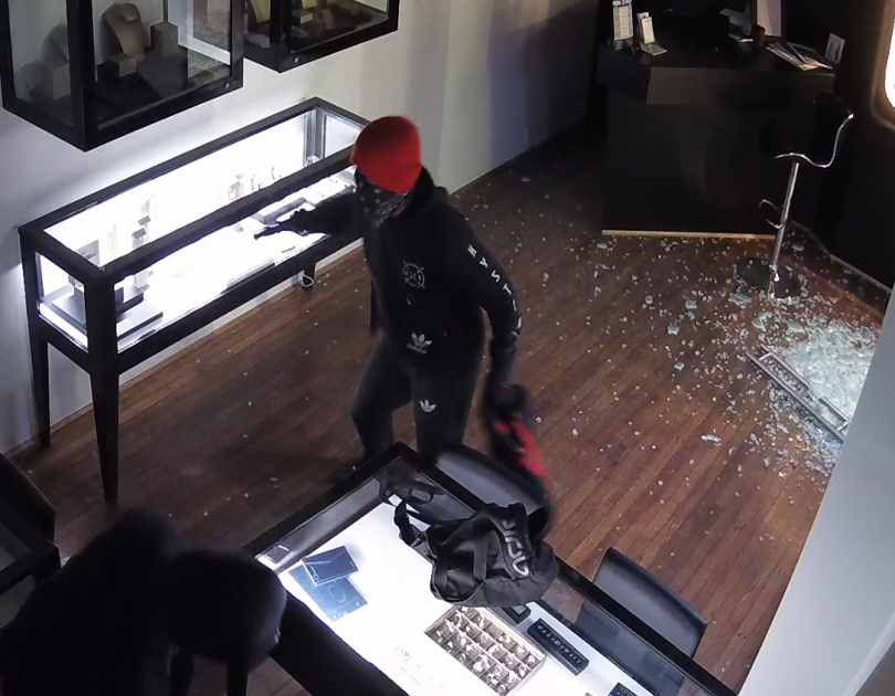 masked robber in store