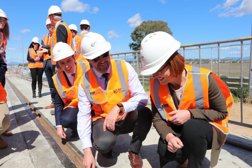 people in vests and hard hats