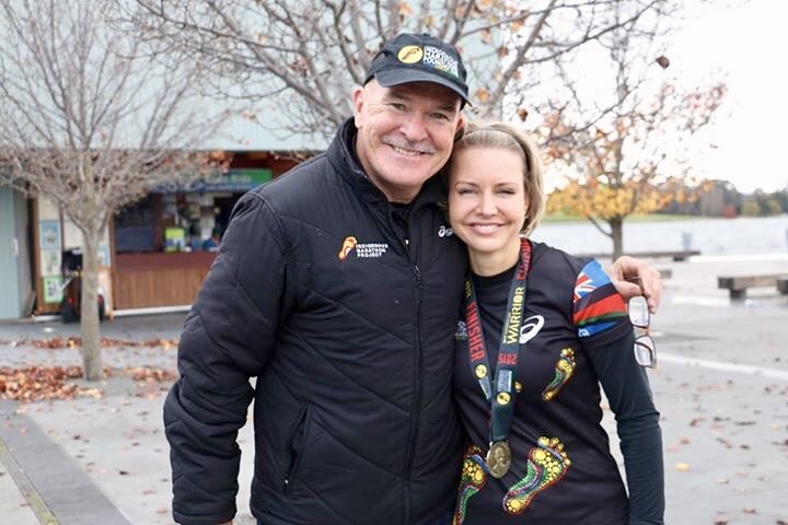 man with arm around woman