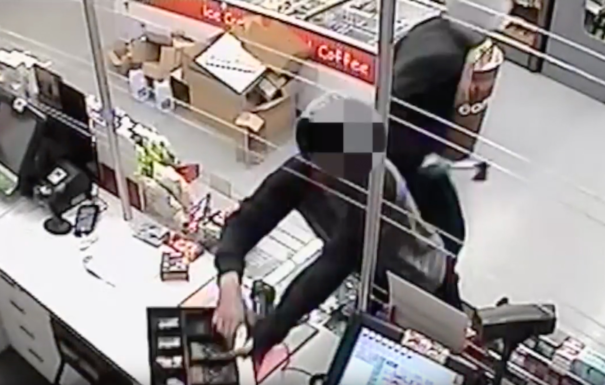 CCTV shows service station attendant threatened with hatchet
