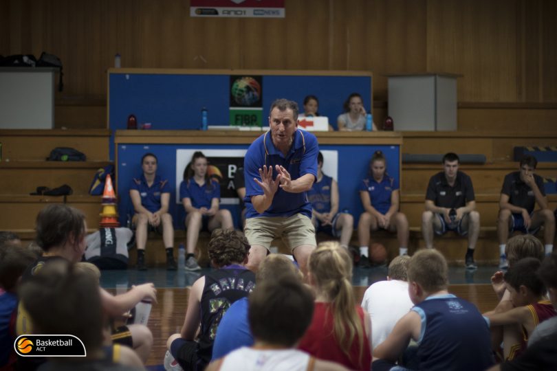 Phil Brown demonstrates shooting technique to his students / Photo by Lachlan Ross.