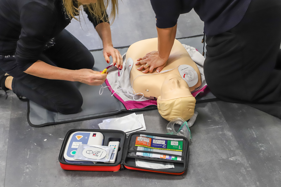 people practicing first aid on a dummy