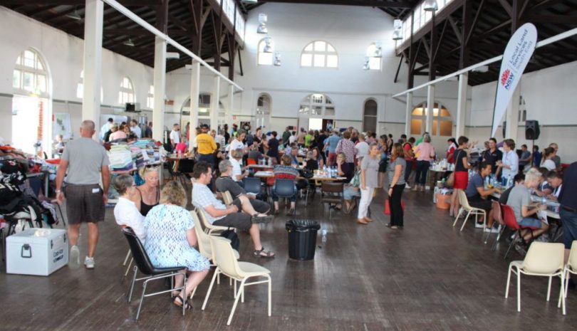 People lined up tonight at the Bega Showground to discover the fate of their home. Photo: Ian Campbell.