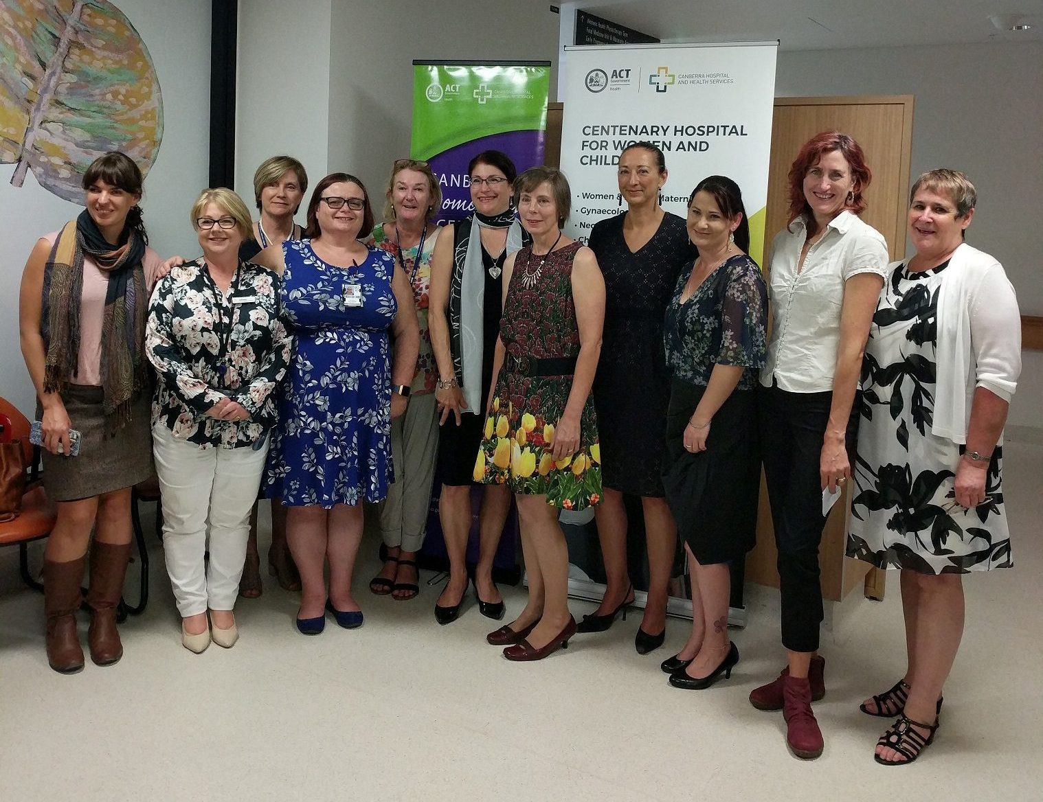 Group of women standing in front of Canberra Endometriosis Centre and ACT Health banners