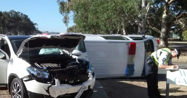 Police van rolls after colliding with car in peak hour traffic