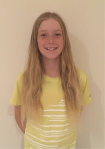 Girl with long blonde hair smiling at the camera