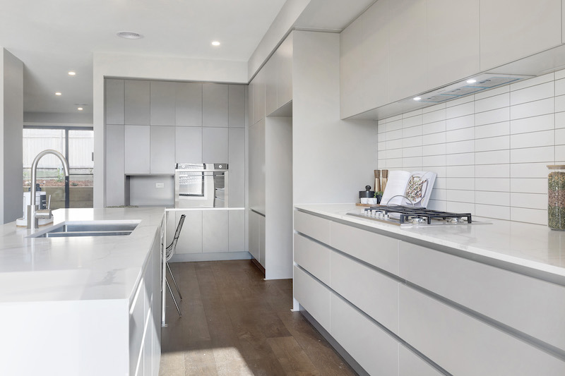 The kitchen, equipped with a breakfast bar, sleek charcoal push cupboards and soft close drawers.