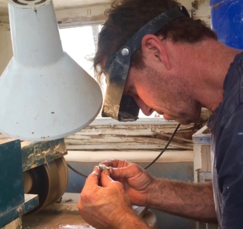 polishing opals he unearthed.