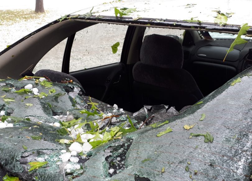 Car with smashed windscreen from hail.
