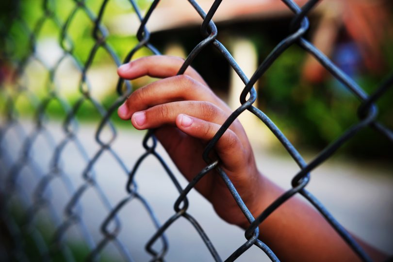 Child behind wire