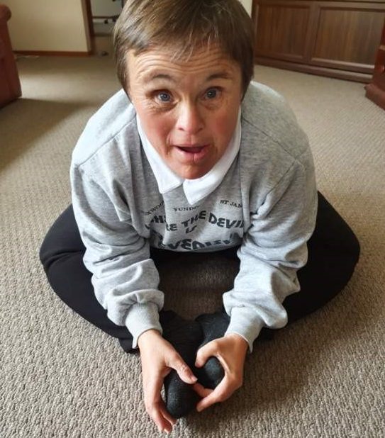 Helen exercising on lounge room floor.