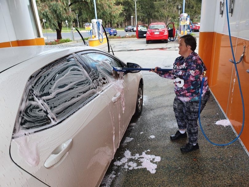 Helen washing vehicle at car wash.