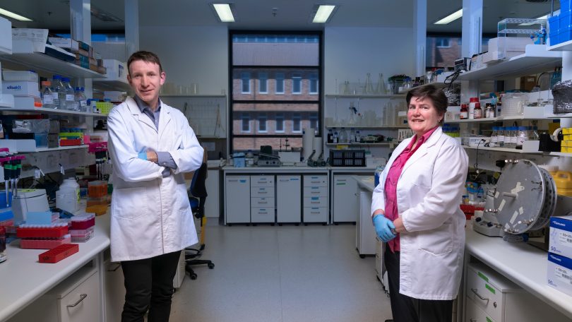 Associate Professor Ian Cockburn and Professor Elizabeth Gardiner standing inside the John Curtin School of Medical Research at ANU.