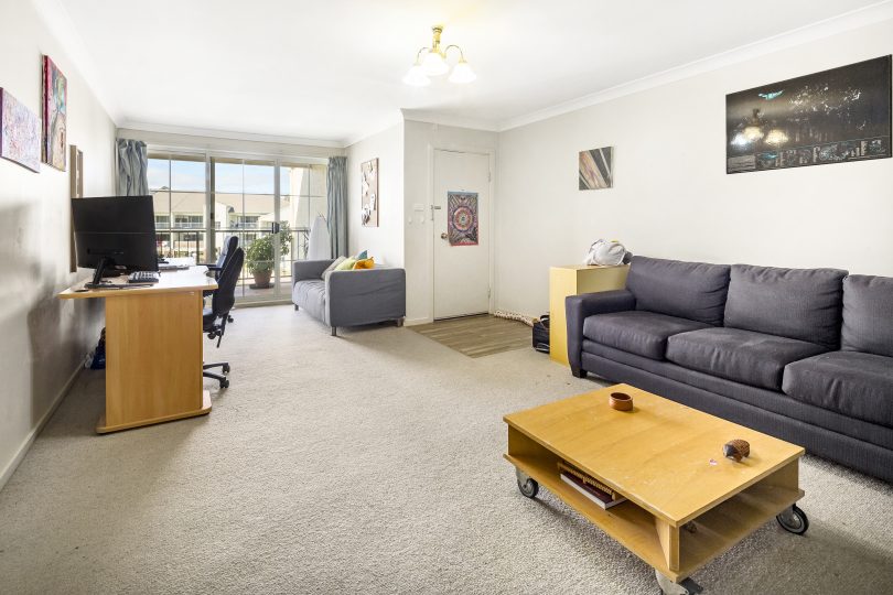 The spacious living room is north-facing and has floor to ceiling glass.