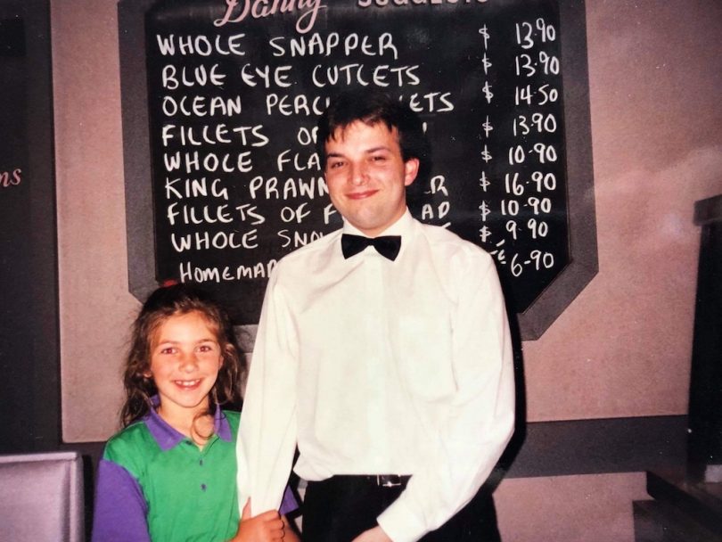 Phillip Stamatellis with cousin Katerina Hrisostoumou in restaurant.