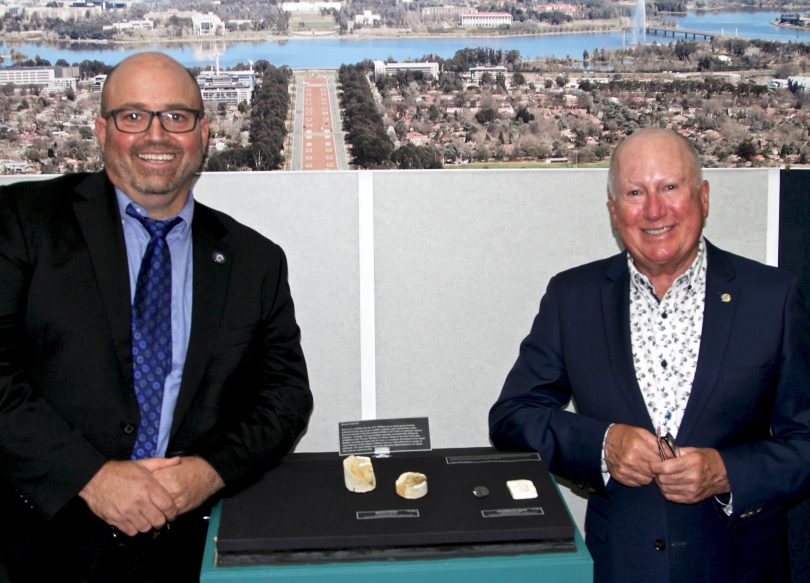 Dr Steve Hill with Mick Gentleman and the ACT fossil emblem.