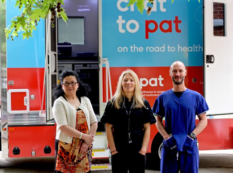 Nurgul Sawut, Ali Loom and Dr Ben Harkness standing in front of PAT van.