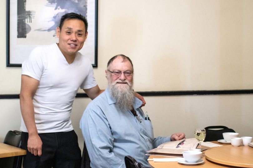 Gavin Chan with Doug, one of the regulars at Happy's Restaurant.