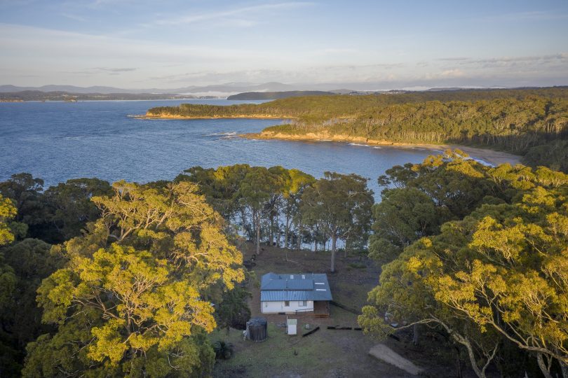 Aerial view of Judges House and surrounding bushland and water.