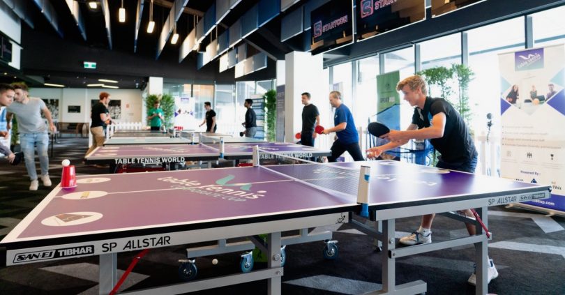 People playing table tennis.