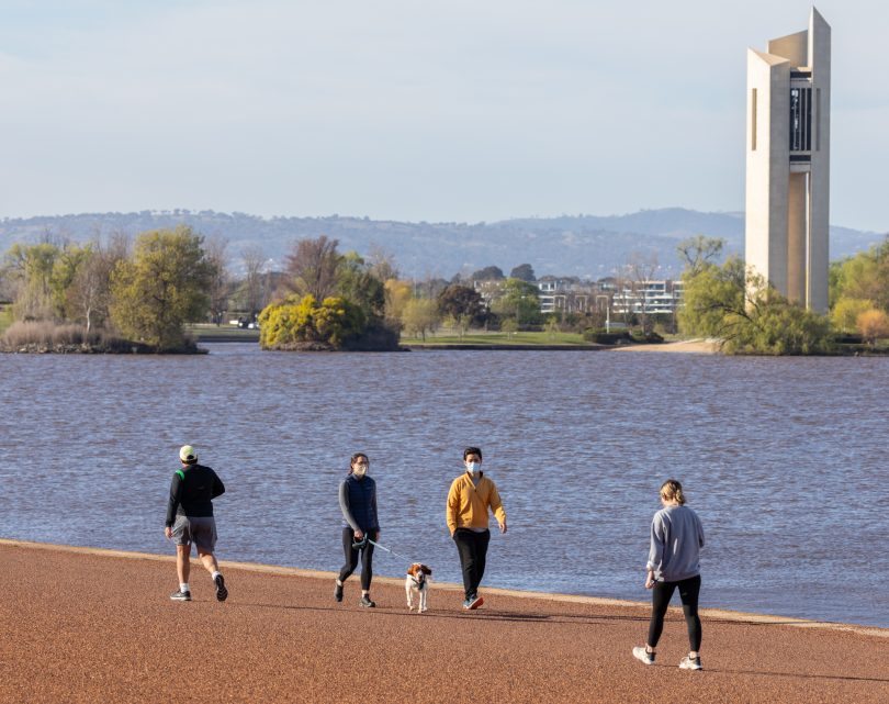 People walking by lake.