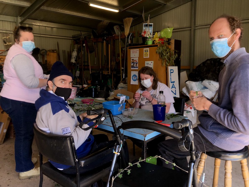 Group of people working around table at Growing Abilities