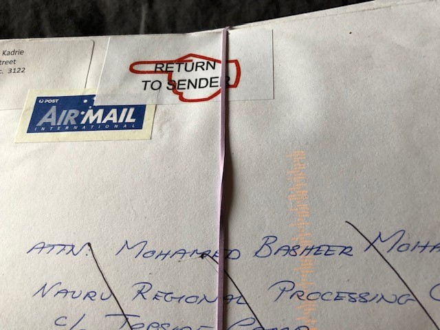 a close up of an envelope with a Return to Sender sticker