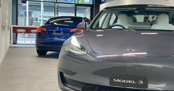 Rising fuel prices cause EV shortage as Canberrans rush to swap petrol for plugs