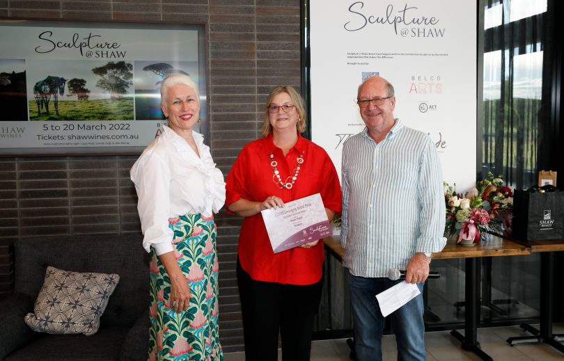 three people with prize certificate