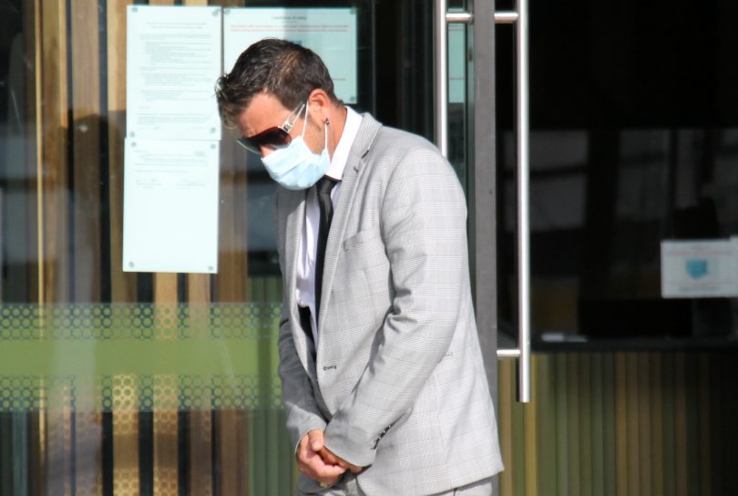 Man leaving court in grey suit