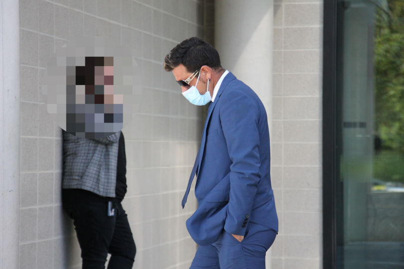 Man leaving court in a blue suit
