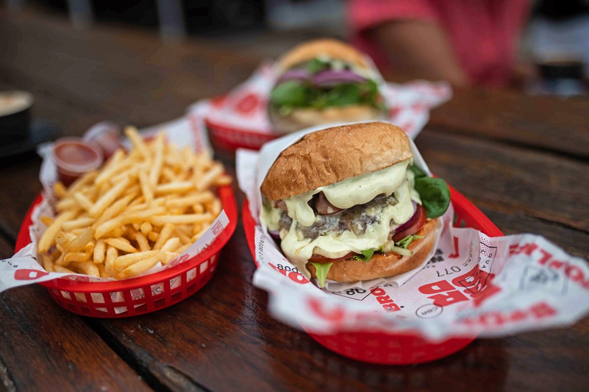 Burgers and chips in red plastic trays