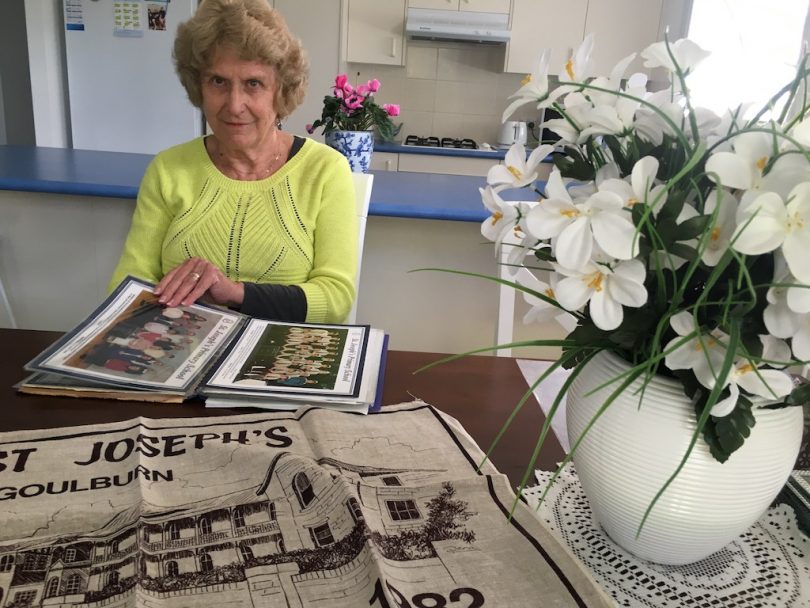 Woman with photo album at a table