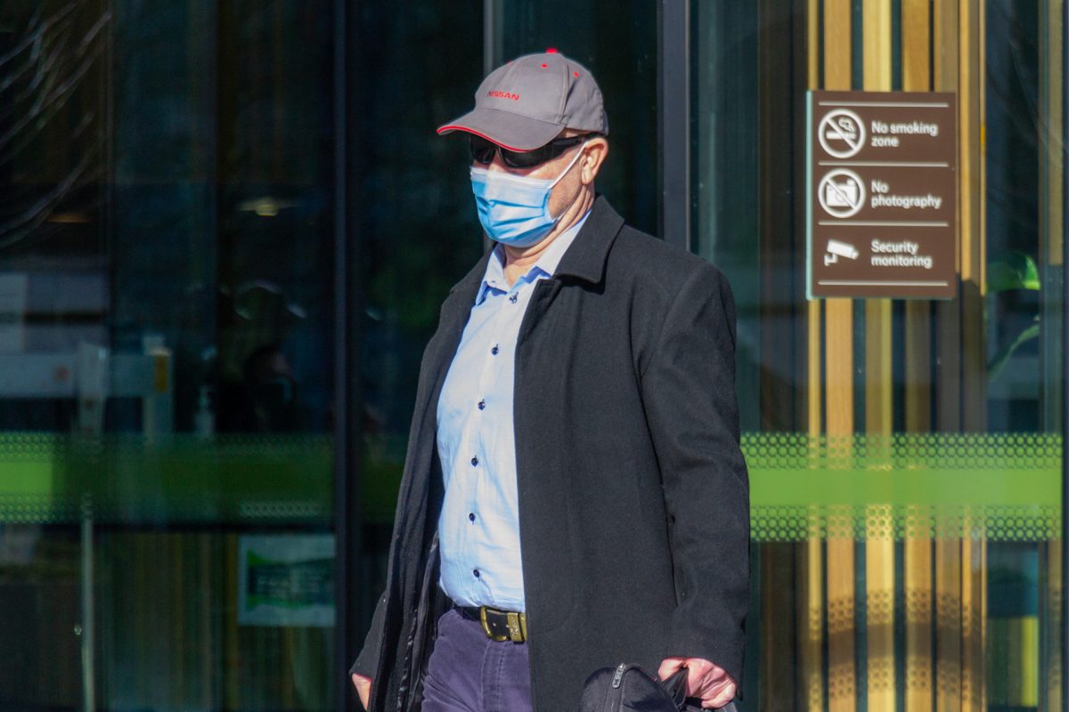 Man in mask leaving court