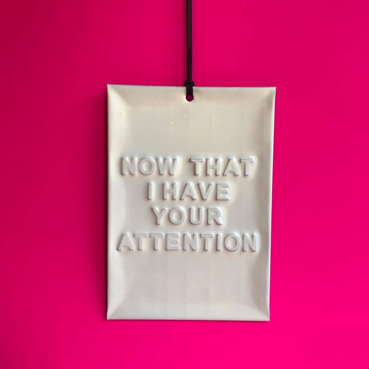 Pendant saying, Now that I have your attention.