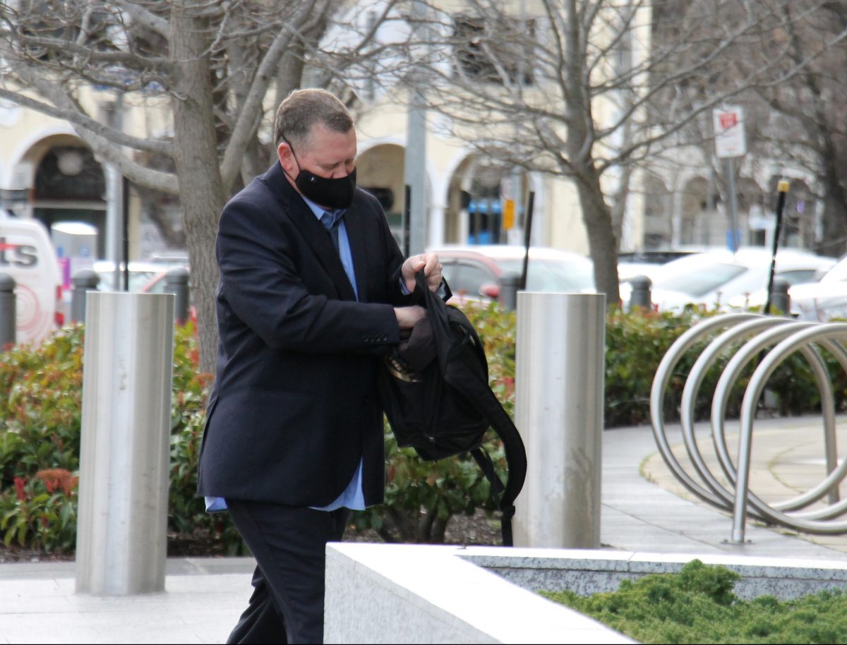 Man with mask walking towards court