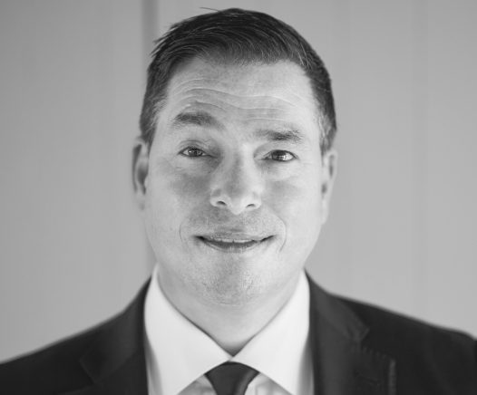 Black and white headshot of Racing and Sports CEO Stephen Crispe