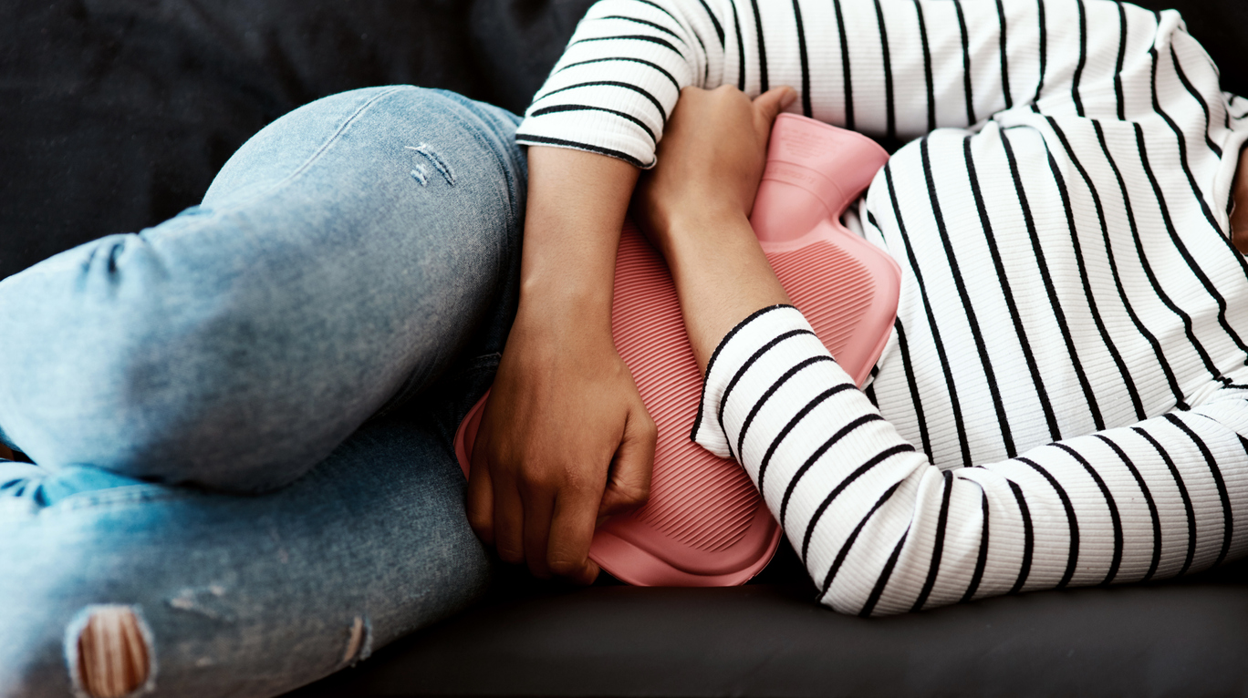 woman holding hot water bottle