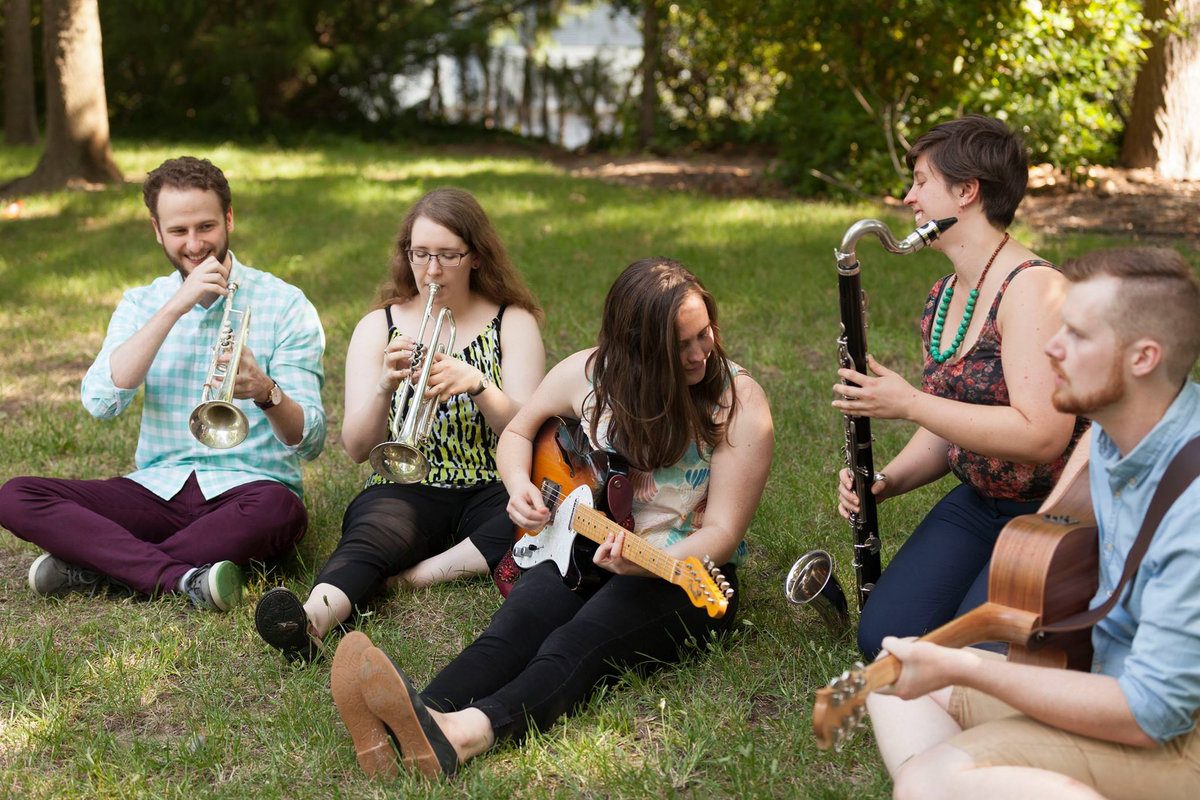 Band sitting on grass