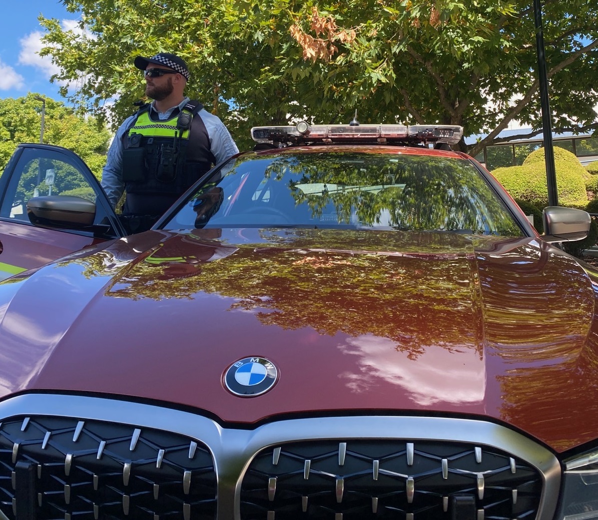 police officer standing next to his vehicle