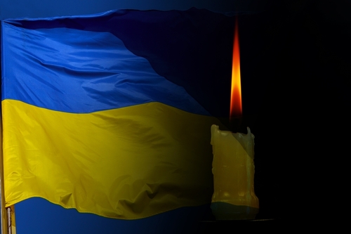 candle and the Ukraine flag