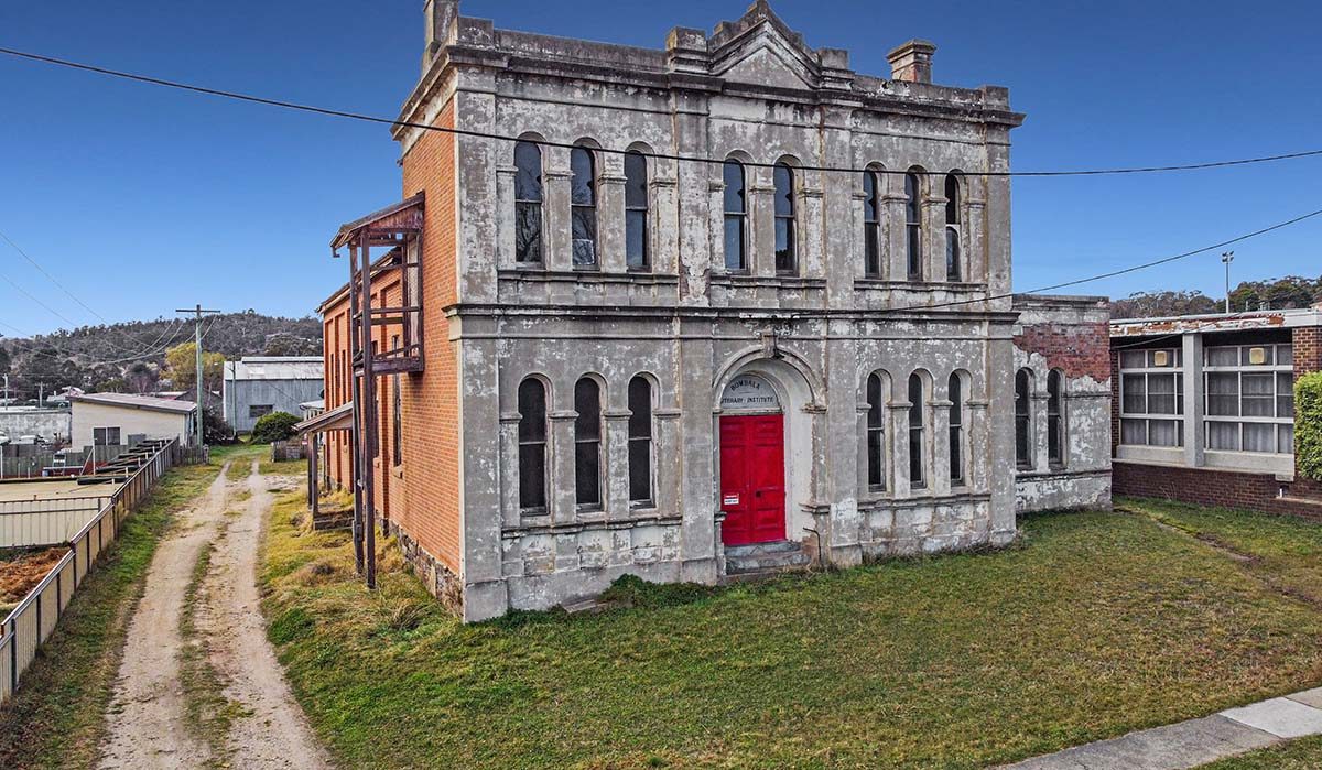 The front of a two-story building with a bright red door