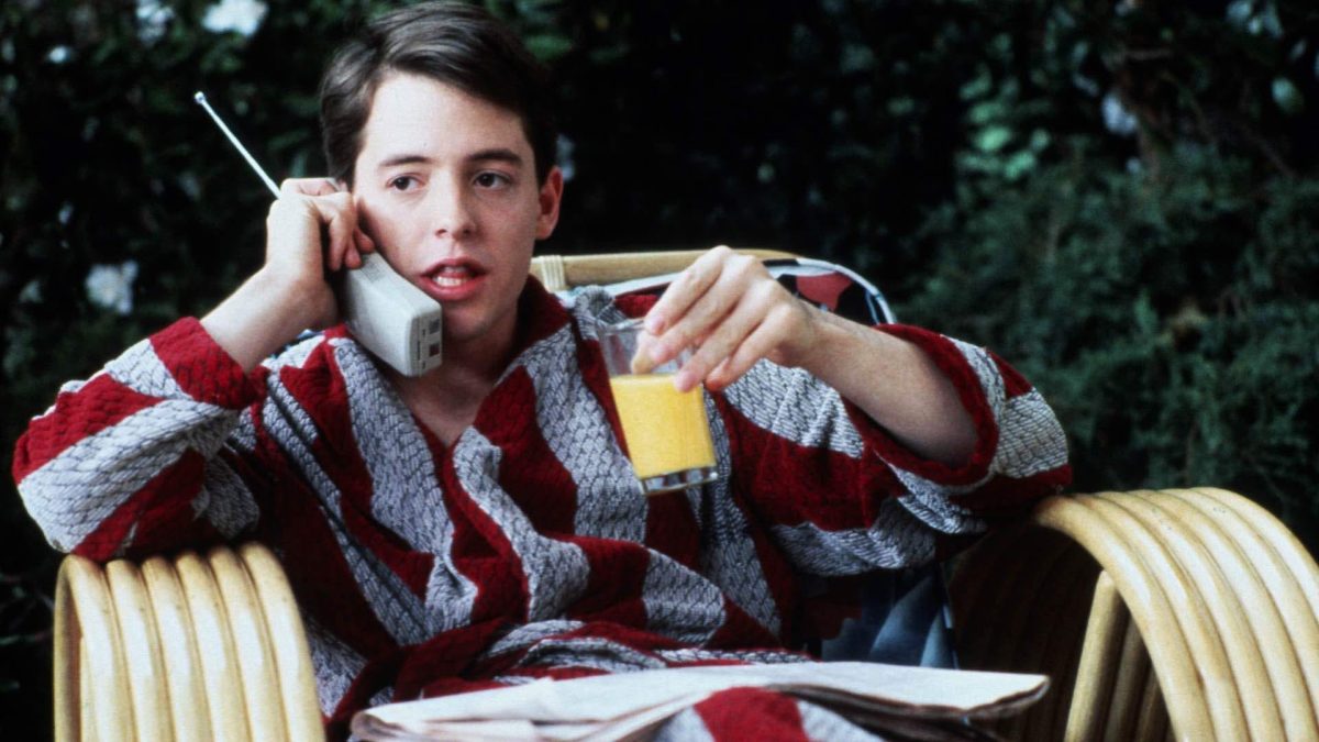 Still from Ferris Bueller's Day Off showing a teenage boy drinking juice and talking on the phone