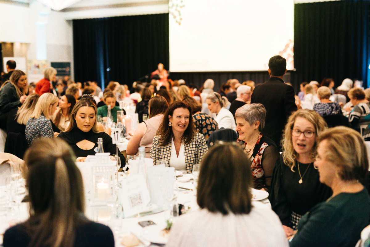 people sitting at a table for a charity luncheon