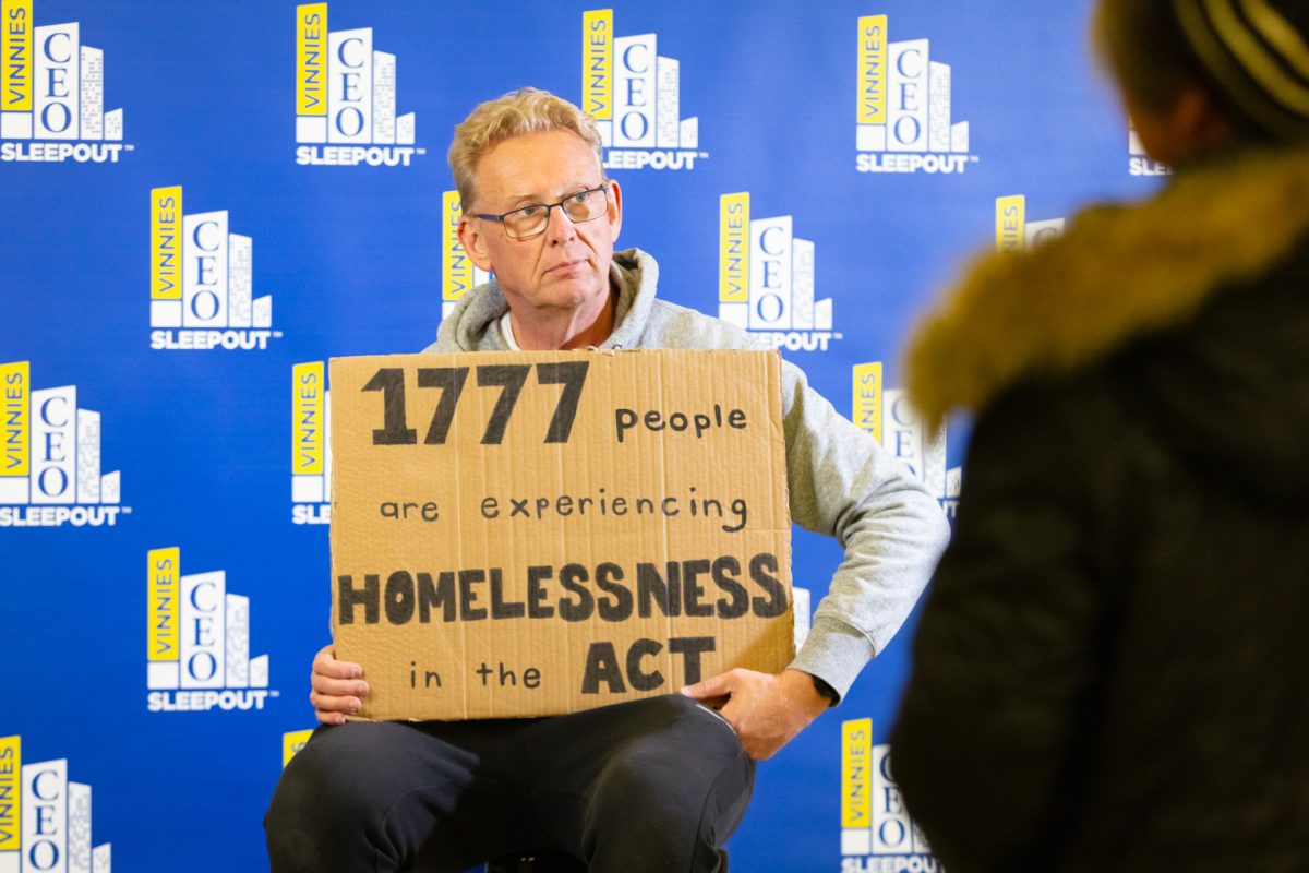 man holding cardboard sign