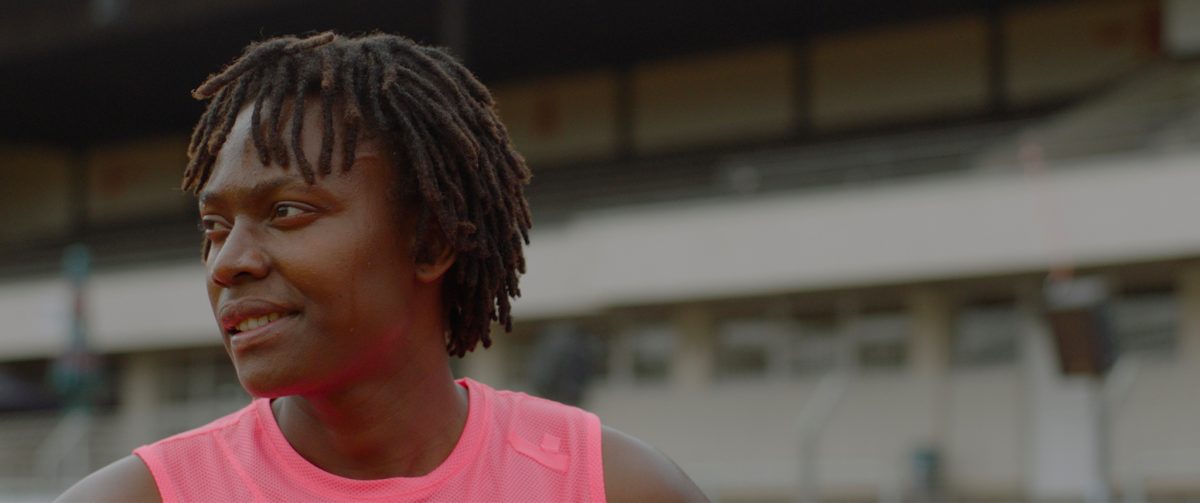 Still from Life Is Not a Competition, But I'm Winning showing the profile of an athlete in a stadium