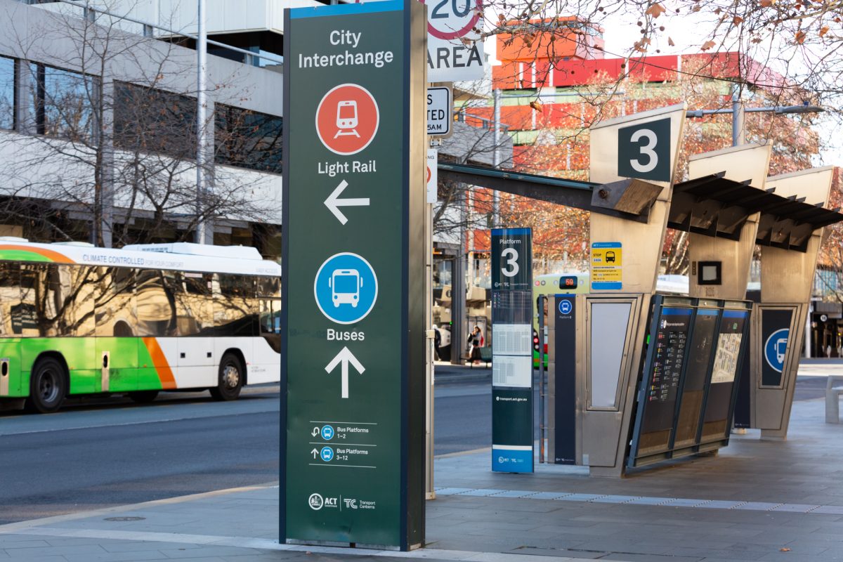 City Interchange sign with bus and bus stop