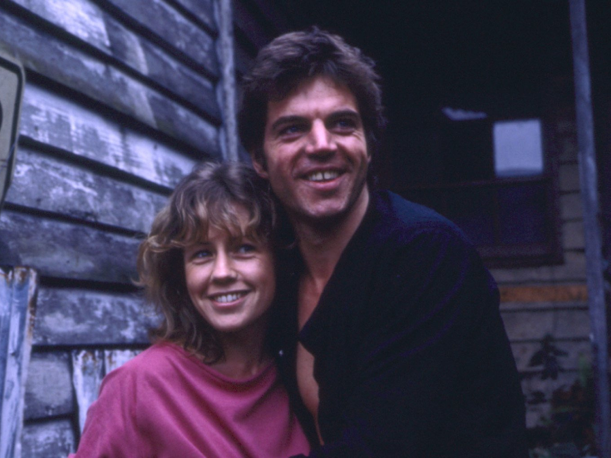 Still from Monkey Grip showing a man and a woman embracing and smiling